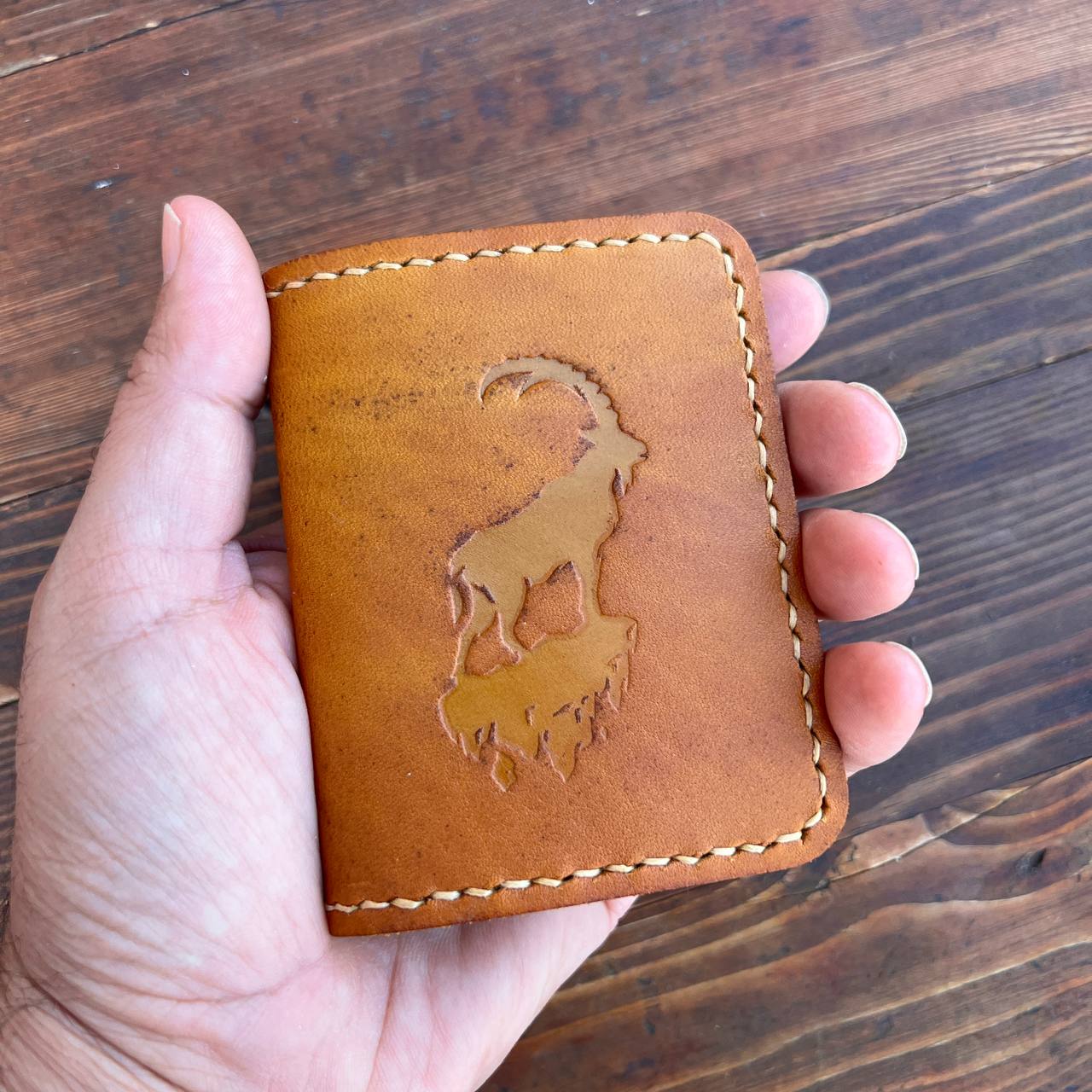 Brown card holder with capra pattern